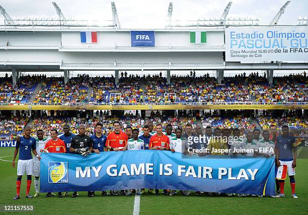 Players and referees pose behind a fair play banner during the FIFA U-20 World Cup Colombia 2011 quarter final match between France and Nigeria on...