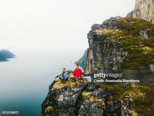 couple with dog resting on the top of the mountain feeling freedom and happiness - norway food stock pictures, royalty-free photos & images