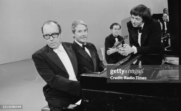 Comedians Eric Morecambe and Ernie Wise in a sketch with pianist Andre Previn for the BBC television series 'The Morecambe and Wise Show', December...