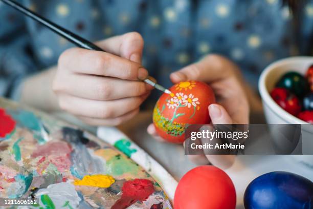 young girl painting on easter egg - easter egg decorating stock pictures, royalty-free photos & images