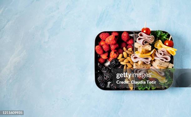 lunch box on blue background - jause stock-fotos und bilder