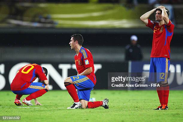 Alvaro Vazquez, Hugo Mallo and Carles Planas of Spain react after the FIFA U-20 World Cup 2011 quarter final match between Brazil and Spain at...