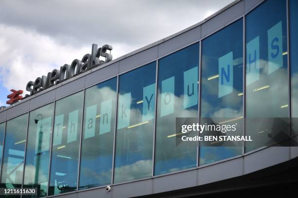 Sign thanks NHS staff who continue to work during the COVID-19 outbreak at Sevenoaks train station, south of London, on May 2 as life in Britain...