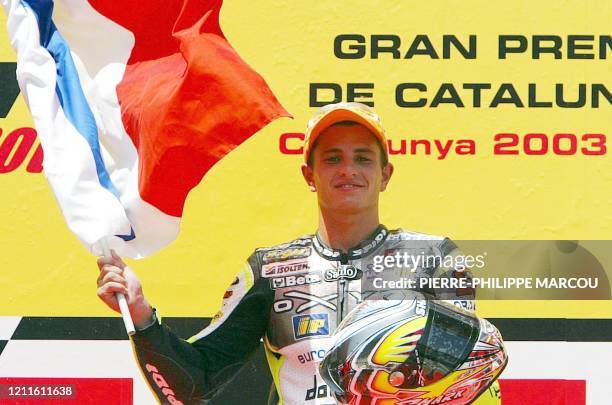 French Randy de Puniet waves his national flag after winning the Grand Prix of Catalunya in the 250 cc category in Montmelo near Barcelona, 15 June...