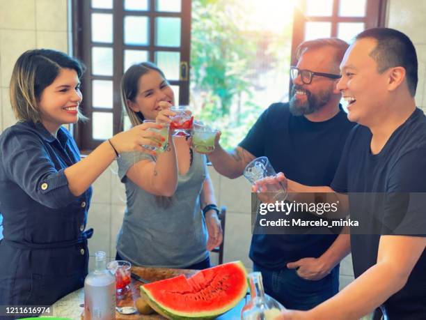 weekend lunch with family, a delicious feijoada with caipirinha. - caipirinha stock pictures, royalty-free photos & images