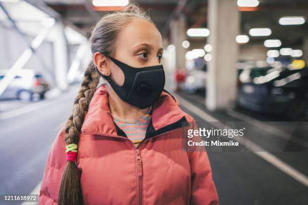 young girl wearing anti-smog face masks for health and lungs protection - air respirator mask stock pictures, royalty-free photos & images