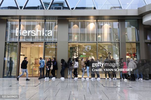 People wait in line to get into a Bershka store on May 2 in Frankfurt am Main, western Germany, amid the coronavirus COVID-19 pandemic.