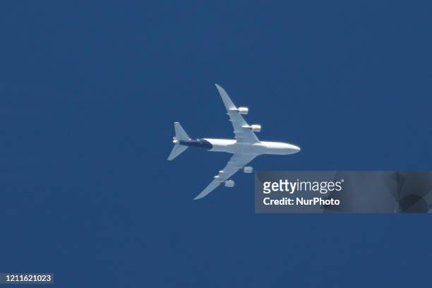 Lufthansa Boeing 747-400 aircraft as seen flying over Greece in the blue sky at 34.000 feet leaving a vapour trail or contrail behind. DLH LH...