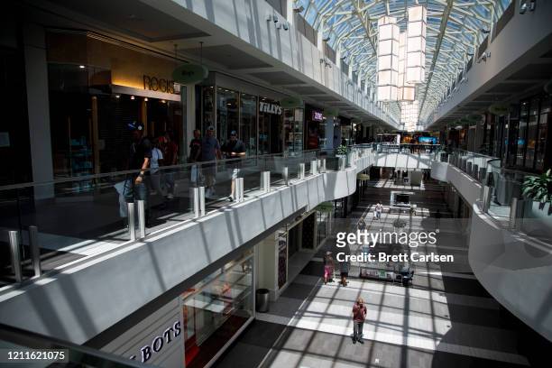 Customers make their way through CoolSprings Galleria shopping mall despite many retail locations inside the mall remaining closed on May 2, 2020 in...