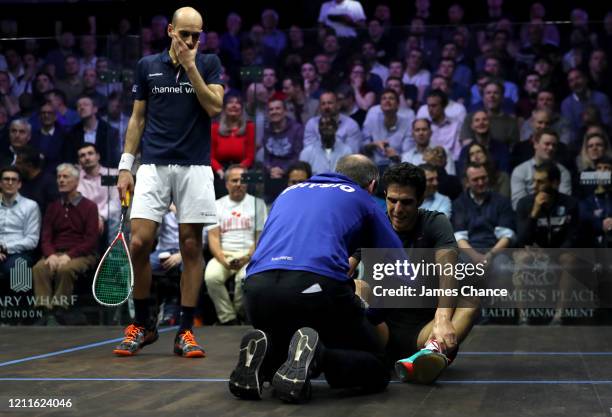 Marwan El Shorbagy of Egypt reacts to Omar Mosaad of Egypt injury during the Second Round match of The Canary Wharf Squash Classic between Omar...