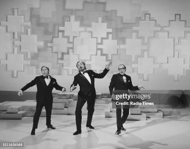 Comedians Eric Morecambe and Ernie Wise , with actor Eric Porter, in a sketch from the BBC television series 'The Morecambe and Wise Christmas Show',...