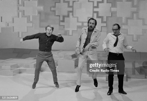 Comedians Eric Morecambe and Ernie Wise , with actor Eric Porter, in a sketch from the BBC television series 'The Morecambe and Wise Christmas Show',...