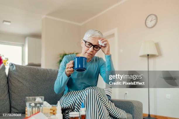 senior woman caught cold - covid 19 symptoms stock pictures, royalty-free photos & images