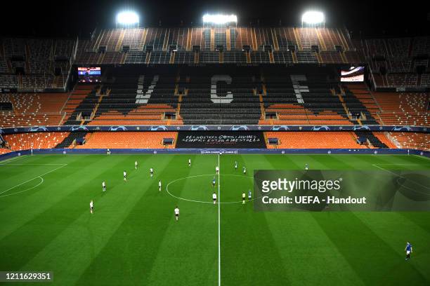 In this handout image provided by UEFA, General view as the match kicks off in an empty stadium ahead of the UEFA Champions League round of 16 second...