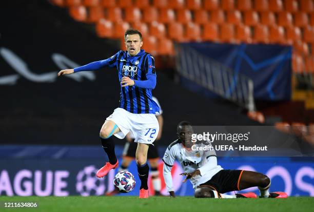 In this handout image provided by UEFA, Josip Ilicic of Atalanta controls the ball as Mouctar Diakhaby of Valencia looks on during the UEFA Champions...