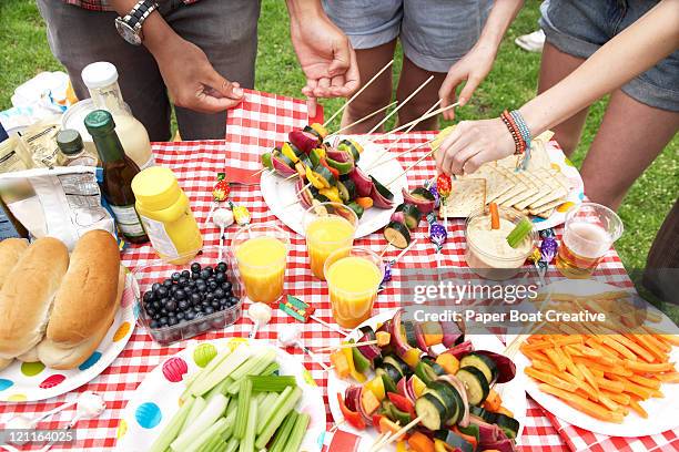 a summer barbecue in the park - picnic table park stock pictures, royalty-free photos & images