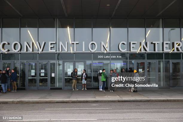 Handful of supporters remain in front of the Huntington Convention Center after Democratic presidential candidate Sen. Bernie Sanders canceled his...