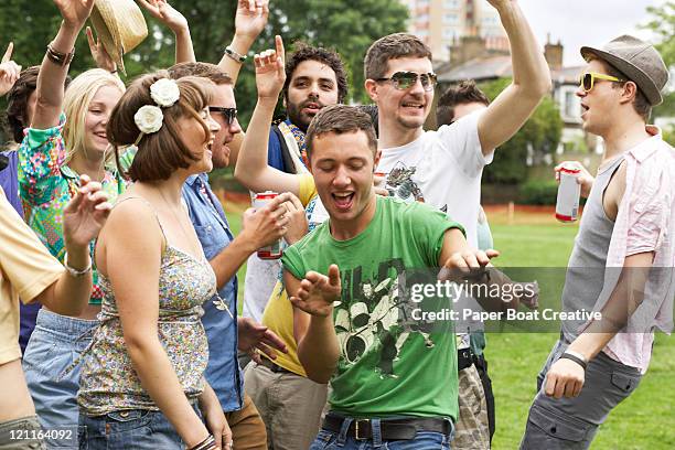 friends dancing together in the park - festivalgoers stock pictures, royalty-free photos & images