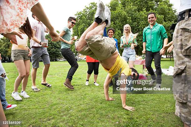 man doing a hand stand in the middle of a circle - freestyle dance stock pictures, royalty-free photos & images