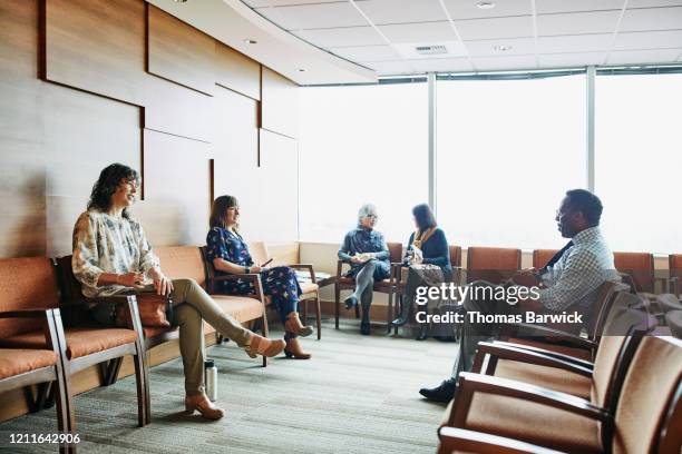 people sitting in medical office waiting room - waiting room - fotografias e filmes do acervo