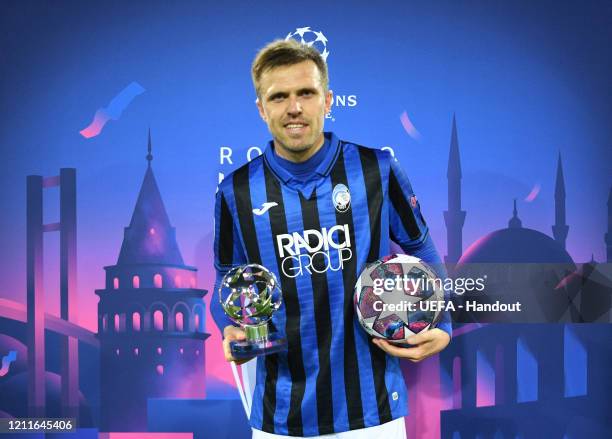 In this handout image provided by UEFA, Josip Ilicic of Atalanta recieves the man of the match award and also the match ball after he scores all 4...