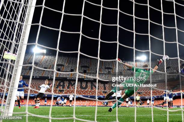 In this handout image provided by UEFA, Josip Ilicic of Atalanta scores his sides fourth goal past Jasper Cillessen of Valencia during the UEFA...