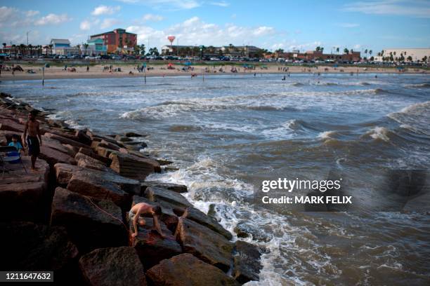 Beachgoers enjoy a day of sunshine at Galveston Beach on May 2, 2020 in Galveston, Texas. - Texas beaches were ordered to be opened on May 1, 2020....