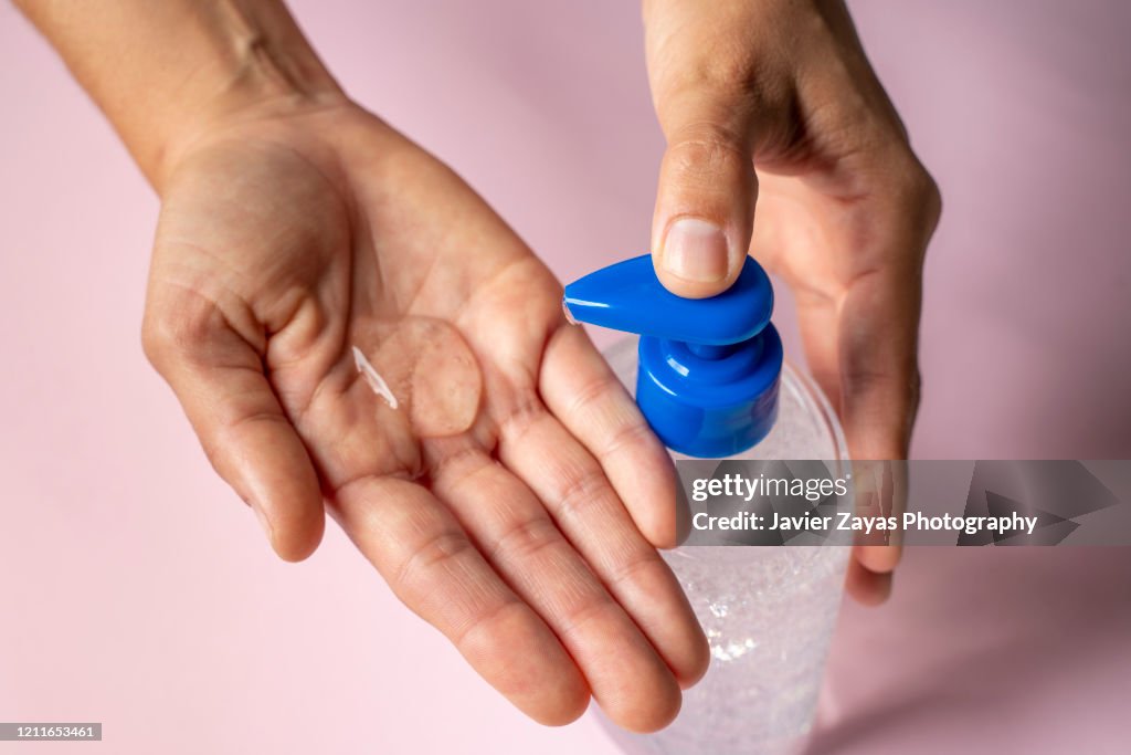 Woman using Alcohol-Based Hand Sanitizer