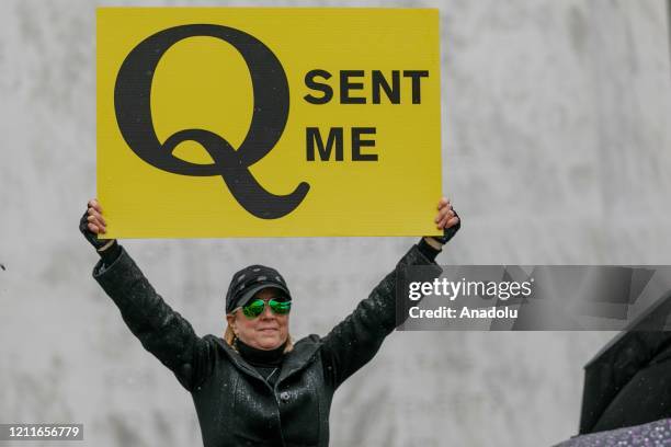 The Q-Anon conspiracy theorists hold signs during the protest at the State Capitol in Salem, Oregon, United States on May 2, 2020. Demonstrators...