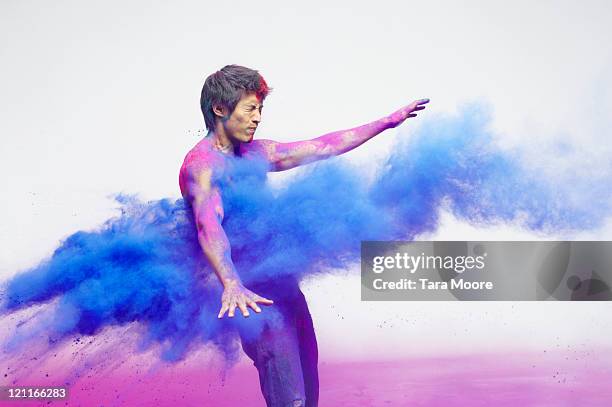 man getting blasted with blue powder - vernice in polvere foto e immagini stock