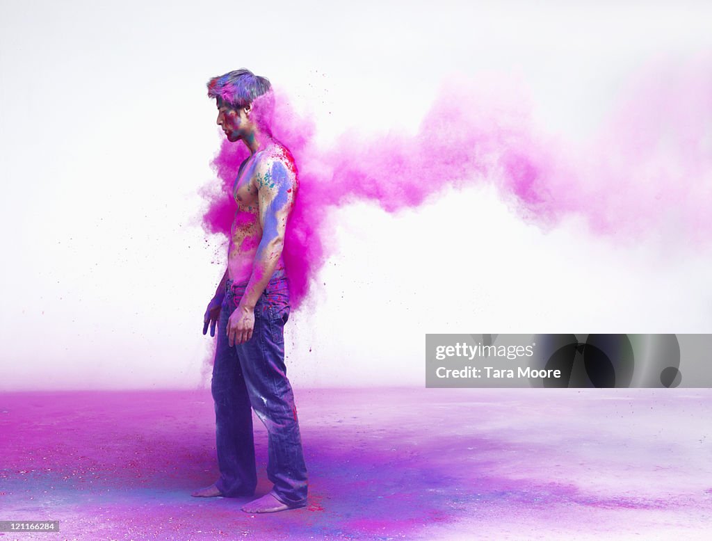 Man getting impacted by pink powder paint