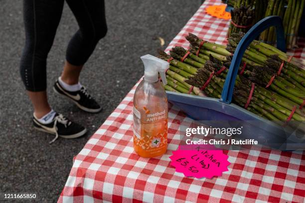 Bottle of hand sanitiser next to asparagus for sale on a stall at Blackheath Farmers Market on May 3, 2020 in London, England. The Office For...