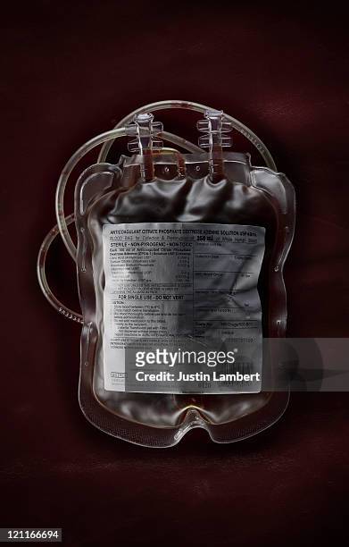 full blood bag on blood red background - blood bag stock-fotos und bilder