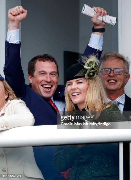 Peter Phillips and Autumn Phillips watch the racing as they attend day 1 'Champion Day' of the Cheltenham Festival 2020 at Cheltenham Racecourse on...