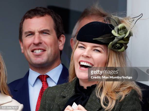 Peter Phillips and Autumn Phillips watch the racing as they attend day 1 'Champion Day' of the Cheltenham Festival 2020 at Cheltenham Racecourse on...