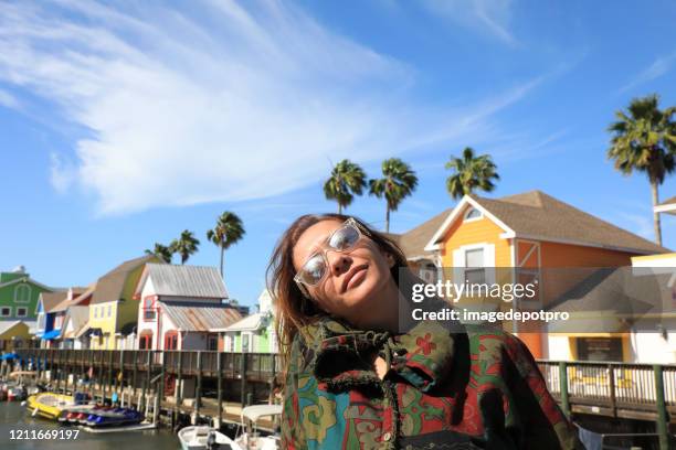 portrait of beautiful adult woman and colorful houses - sarasota stock pictures, royalty-free photos & images