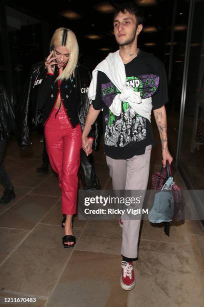 Dua Lipa and boyfriend Anwar Hadid are seen on a night out having dinner with family at The Ivy Asia St Paul's on March 10, 2020 in London, England.