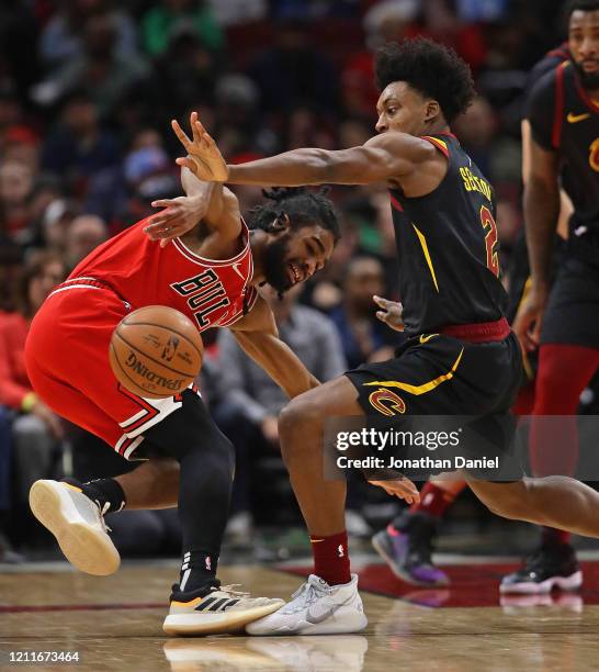 Collin Sexton of the Cleveland Cavaliers knocks the ball away from Coby White of the Chicago Bulls at the United Center on March 10, 2020 in Chicago,...