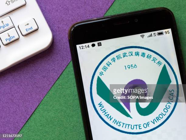 In this photo illustration a Wuhan Institute of Virology logo seen displayed on a smartphone.
