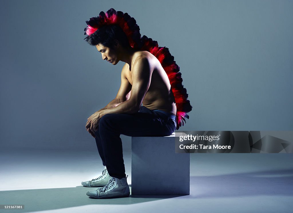 Man wearing feather head dress