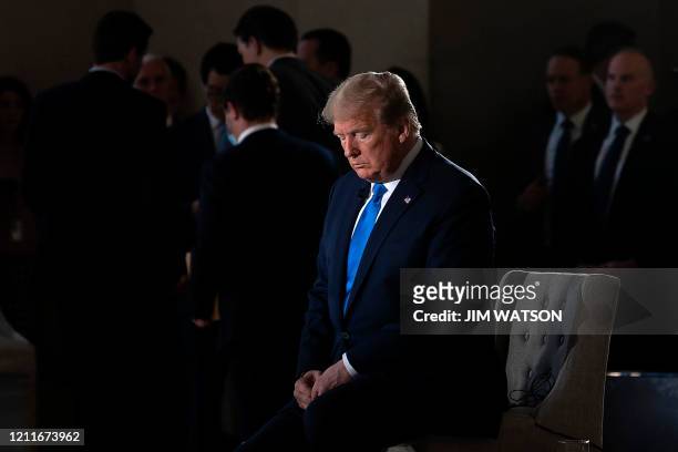 President Donald Trump gestures during a commercial break of a Fox News virtual town hall "America Together: Returning to Work," event from the...