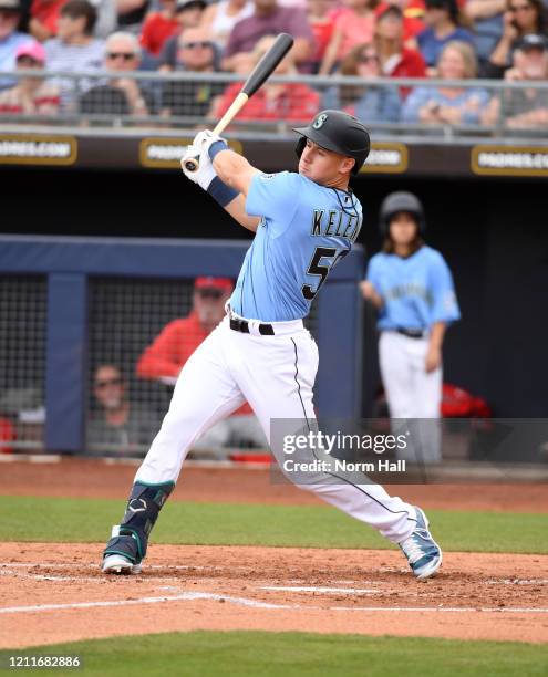 Jarred Kelenic of the Seattle Mariners follows through on a swing against the Los Angeles Angels during a spring training game at Peoria Stadium on...