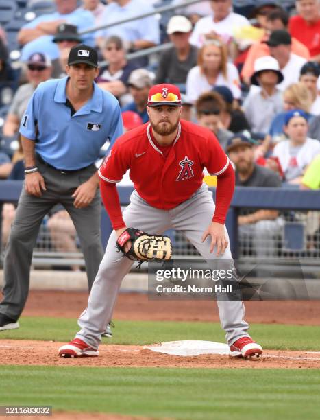 Jared Walsh of the Los Angeles Angels gets ready to catch a throw from pitcher Dylan Bundy during a spring training game against the Seattle Mariners...