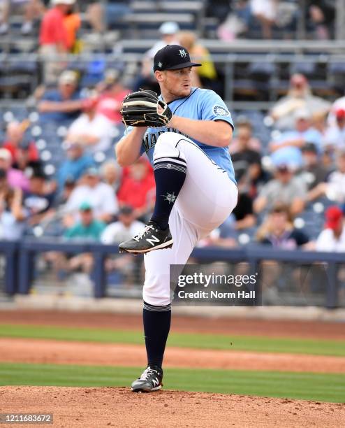 Ljay Newsome of the Seattle Mariners delivers a pitch against the Los Angeles Angels during a spring training game at Peoria Stadium on March 10,...