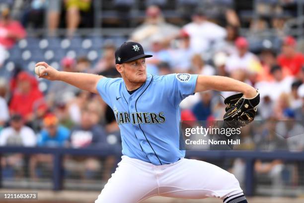 Ljay Newsome of the Seattle Mariners delivers a pitch against the Los Angeles Angels during a spring training game at Peoria Stadium on March 10,...