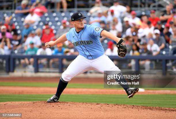 Ljay Newsome of the Seattle Mariners delivers a pitch against the Los Angeles Angels during a spring training game at Peoria Stadium on March 10,...