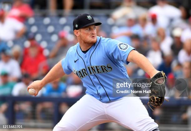 Ljay Newsome of the Seattle Mariners delivers a pitch against the Los Angeles Angels during a spring training game at Peoria Stadium on March 10,...