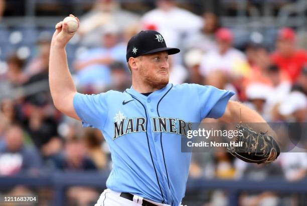 Ljay Newsome of the Seattle Mariners delivers a pitch against the Los Angeles Angels during a spring training game at Peoria Stadium on March 10,...