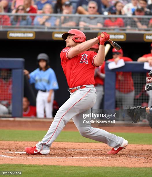 Max Stassi of the Los Angeles Angels follows through on a swing during a spring training game against the Seattle Mariners at Peoria Stadium on March...