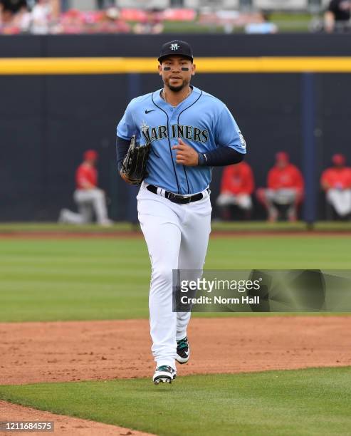 Carlos Gonzalez of the Seattle Mariners runs in from right field against the Los Angeles Angels during a spring training game at Peoria Stadium on...